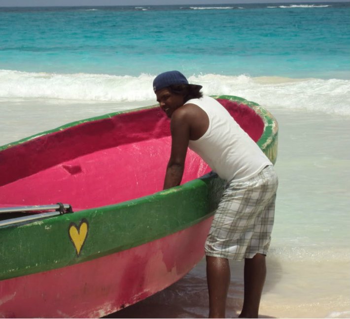 Man with pink boat in Tulum, Mexico.