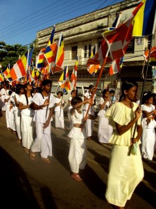 A parade with girls holding flags.